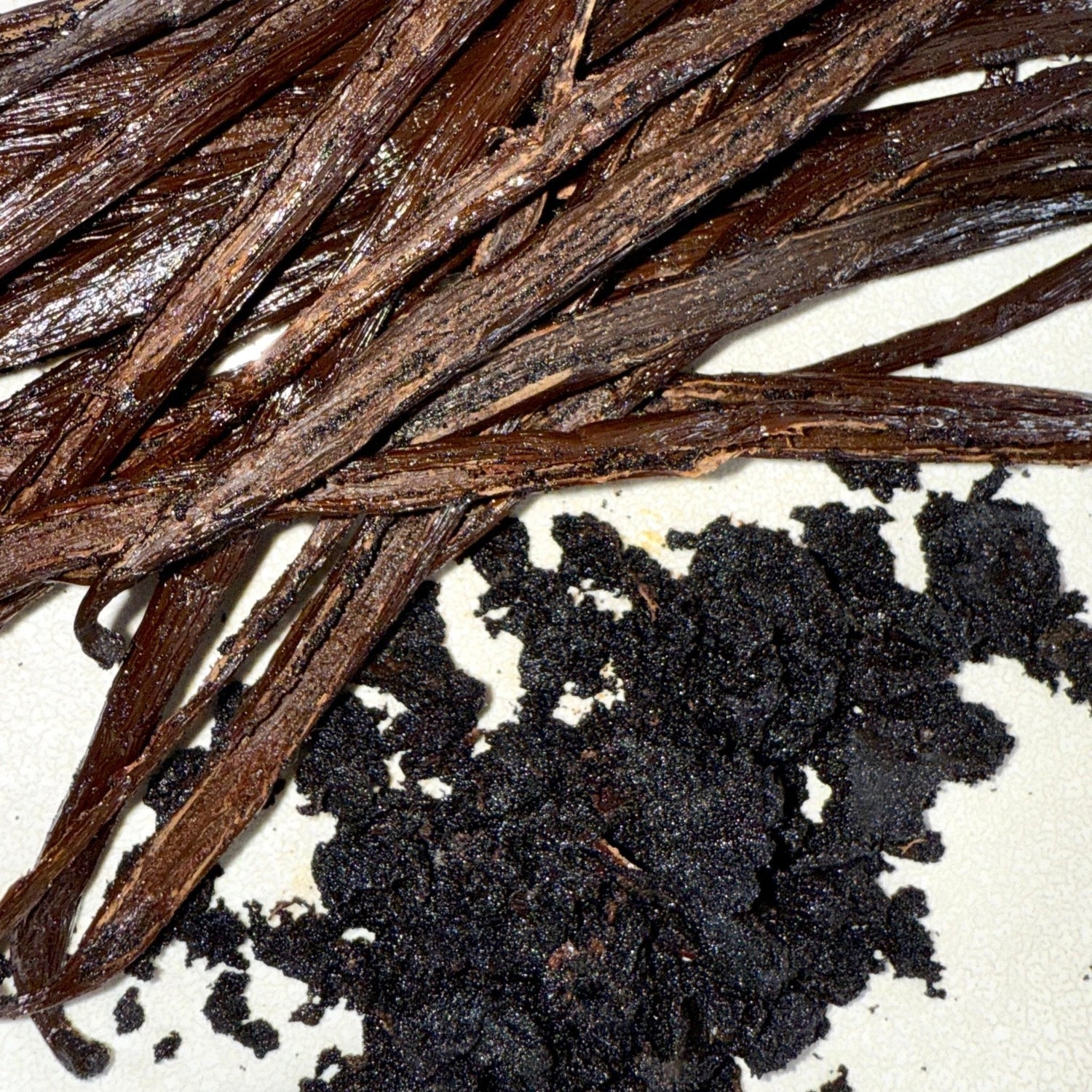 A bunch of black beans in a wooden tray